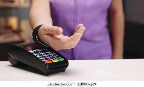 Contactless payment with your smart watch. Wireless payment concept. Close-up, woman using smartwatch cashless wallet NFC technology to pay order on bank terminal. Mobile payment. - Powered by Shutterstock