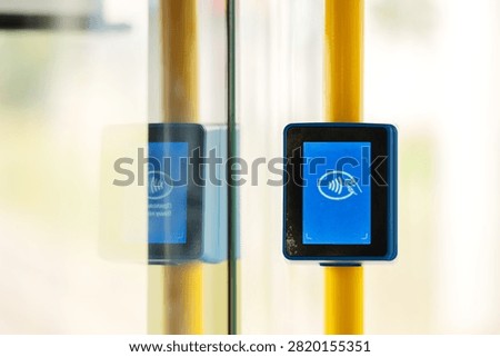 Contactless ticket validator terminal inside public transport. Electronic payment machine for credit cards and travel passes on city bus, train, or tram.