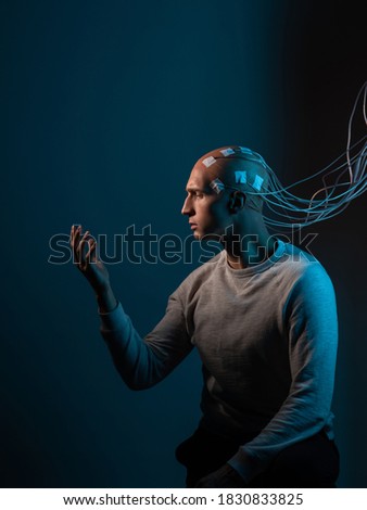 Contacts connected to the brain, reading brain signals, studying intelligence and brain activity. A bald man with electrodes in his brain