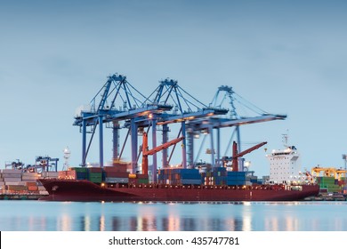 Container Cargo freight ship by crane bridge, logistics harbor at sunrise