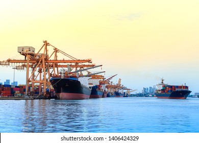 Container cargo freight ship with crane bridge in shipyard at twilight for logistic Import an export. Industrial and transportation concept