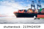 Container cargo freight ship during discharging at industrial port move to container yard by trucks, handlers, cargo plane, copy space, logistic import export background and transport industry concept