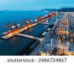 Container Cargo freight ship with working crane bridge in shipyard at dusk for Logistic Import Export background