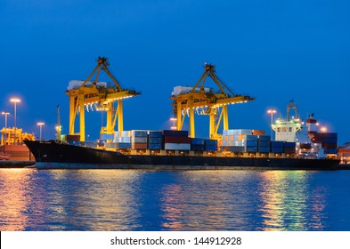 Container Cargo Freight Ship With Working Crane Bridge In Shipyard