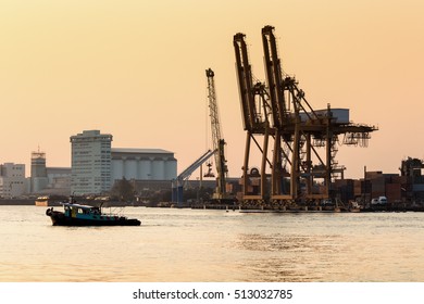 Container Cargo freight ship with working Import Expor tduring sun rise time in Chao praya river,Thailand