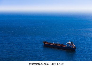 Container Cargo Ship In The Blue Sea. View From Above