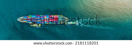 Container cargo ship was dragged by tug boat to international cargo port shipyard for service transport, logistic service transportation and maintenance insurance concept