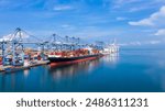 Container cargo ship at industial port in import export business logistic and transportation of international by container cargo ship in the open sea,