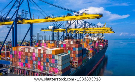 Container cargo ship at industrial port in import export commercial trade business logistic and transportation of international by container cargo ship boat in the open sea, Aerial view industry crane