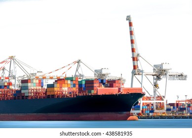 Container Cargo Ship with working crane bridge in shipyard isolated on white background, Freight Transportation, Logistic Import Export background.