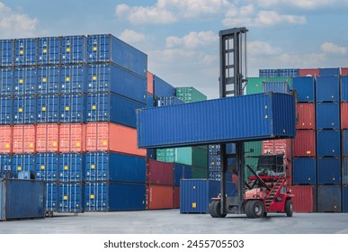 Container handler forklift lifting in shipping yard. Crane lifting up container in yard. Shore crane loading containers in freight ship.