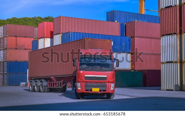 Container handling.\
Container truck picking up container at yard. Port logistics,\
container yard operation.\
