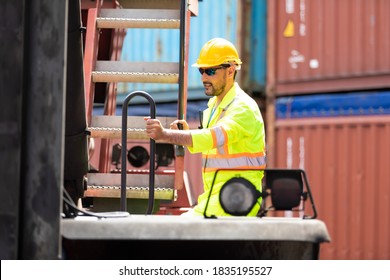 Container hispanic man worker talking on walkie-talkie to Colleague at container warehouse. Marine and carrier insurance concept
