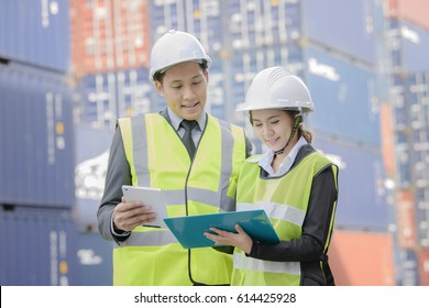 container inspector working in yard with communication device online report number checking