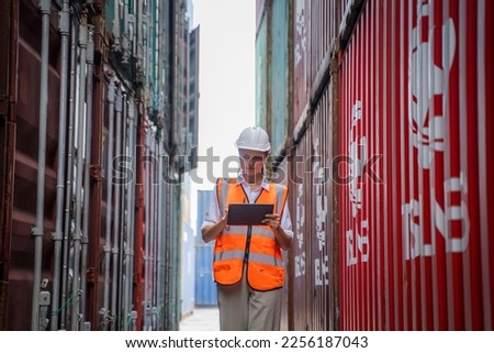 Container operator inspection containers box from cargo ship for export and import at container yards.