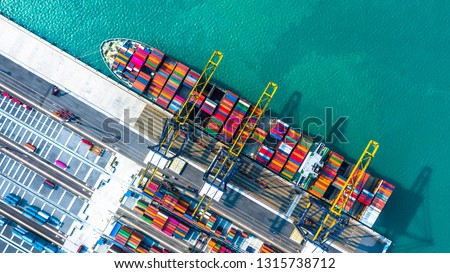 Container ship arriving in port, container ship loading at deep sea port, Logistic business commercial trade import export shipping and transportation, Aerial view, Dubai, United Arab Emirates.