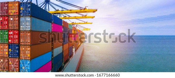 Container ship carrying container box in import\
export with quay crane, Global business cargo freight shipping\
commercial trade logistic and transportation oversea worldwide by\
container vessel.