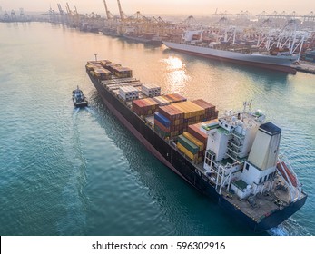 container ship commercial vessel arrival to the port channel due, assist by the tugs boat for safety entrance at gateway of the international port worldwide logistics services