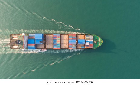 Container ship in export and import business and logistics. Shipping cargo to harbor by crane. Water transport International. Aerial view