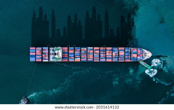 Container ship in export and import business and\
logistics. Shipping cargo to harbor by crane. Water transport\
International. Aerial view and top\
view.