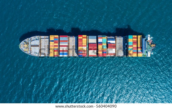 Container ship in export and import business and\
logistics. Shipping cargo to harbor by crane. Water transport\
International. Aerial\
view