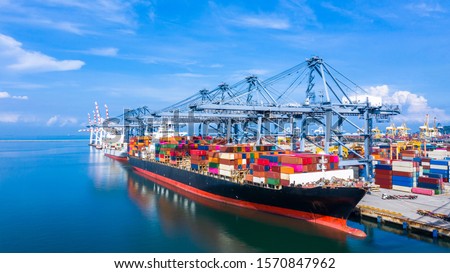 Container ship at industrial port in import export business logistic and transportation of international by container ship in the sea, Container loading in cargo freight ship with industrial crane.