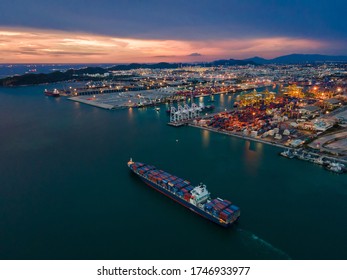 Container ship leaving the port, aerial view, Logistics and transportation of Container Cargo ship, sun set