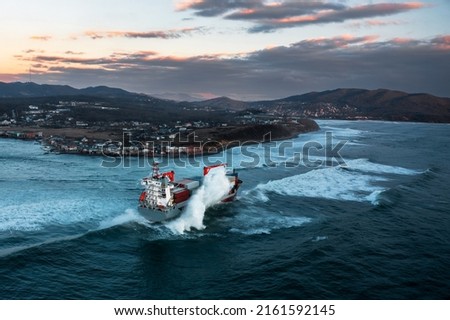 Container ship on stormy sea delivering cargo