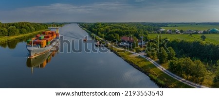Container ship, pilot boat in action by station for vessels navigating on the Kiel Canal. German pilot boats with container ship by changing of marine pilot. Pilot station Rüsterbergen, Schülp Germany