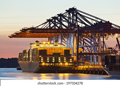 Container Ship At A Terminal At Dusk