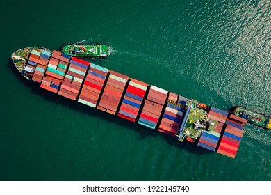 Container ship transporting large cargo logistic and tugboat to import export goods internationally around the world, including Asia Pacific and Europe, by deep sea Mediterranean Aerial view photograp