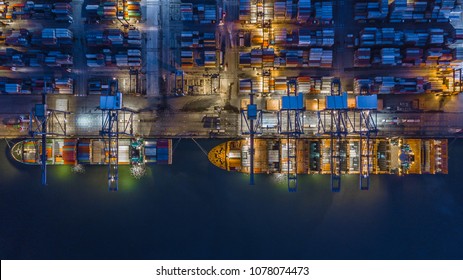 Container ship working at night, Business import export logistic and transportation of international global trading by container ship in the open sea, Aerial view freight cargo terminal at night.