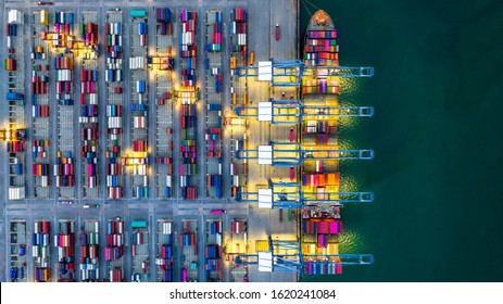 Container ship working at night, Business import export logistic and transportation of International by container ship in the open sea, Aerial view industrial crane loading cargo freight port, Dubai. - Shutterstock ID 1620241084