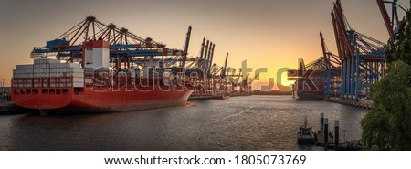 Container ships in the port of Hamburg at sunset 