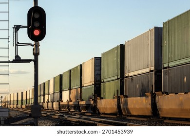 A container stack train passing signals into the distance