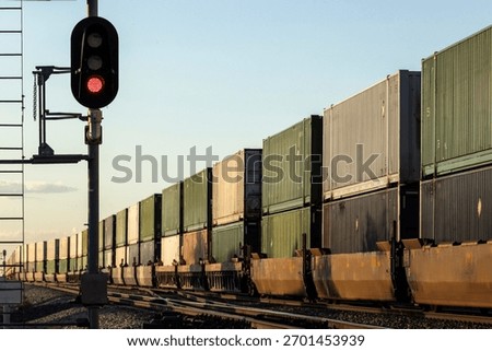 A container stack train passing signals into the distance