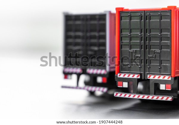 Container truck selective focus on\
white background, Trailer container truck parking at warehouse,\
Global business logistic and transportation shipping\
company.