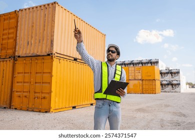 Container yard worker checking container at container yard warehouse.