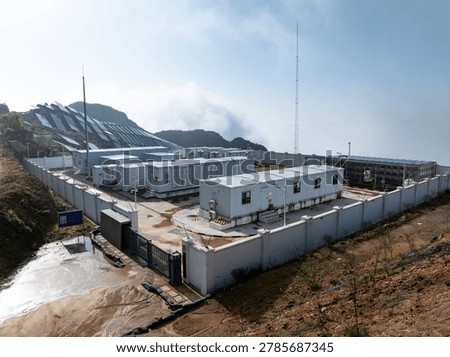 Containerized data center facility located in mountainous terrain with perimeter security and power infrastructure