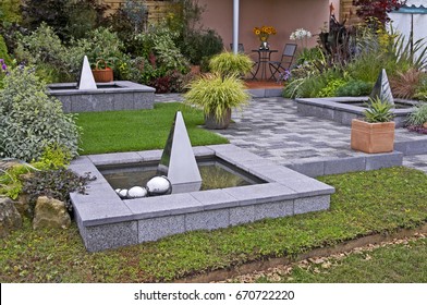 Containers Of Carex Grass And Water Features In A Patio In A Contemporary Garden Design