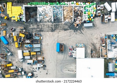 A lot of containers for collecting city garbage, sorting and processing garbage, a garbage truck for transporting and collecting garbage. View from above - Shutterstock ID 2172224463
