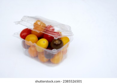 Containers plastic transparency with, Different sorts of tomatoes isolated on white background. Fresh, ripe type of small and round cocktail tomatoes, of red, yellow and orange color. - Powered by Shutterstock