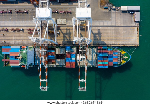 containers shipping
terminal and crane loading unloading trailer truck transportation
aerial top view
