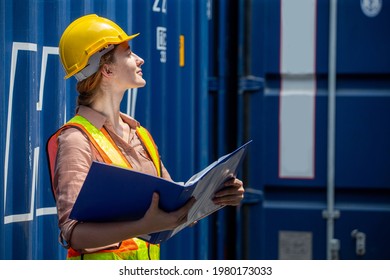Containers woman worker using Folders file to inspection Containers box . female foreman Check inventory by Documents at warehouse logistic in Cargo freight ship for import export. shipping 