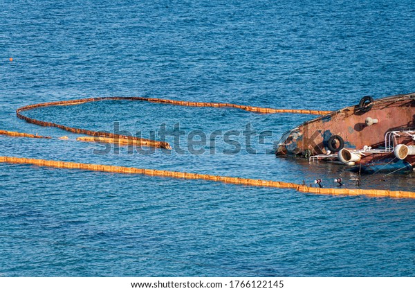 Containment Boom as Temporary Floating Barrier\
Used to Contain an Oil Spill After Tanker Wreck in Storm.\
Environmental Disaster Prevention\
Equipment