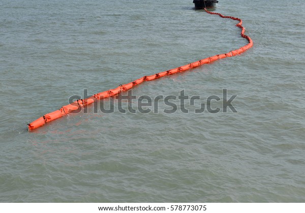 A containment boom is a temporary floating\
barrier used to contain an oil spill. Booms are used to reduce the\
possibility of polluting shorelines and other resources, and to\
help make recovery easier.