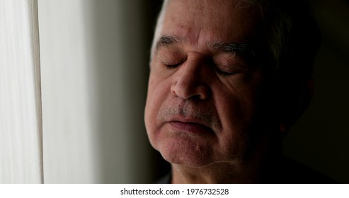 Contemplative 60 Year Old Man Looking Outside During Quarantine