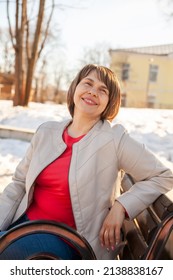 Contemplative Casual Mature Woman   Sitting On Bench In Spring Park