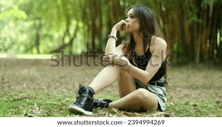 Contemplative millennial girl park thinking. Melancholical young woman in outdoors