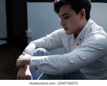 Contemplative moment of a young man indoor setting portrait photography emotional atmosphere side view reflection on life choices - Powered by Shutterstock